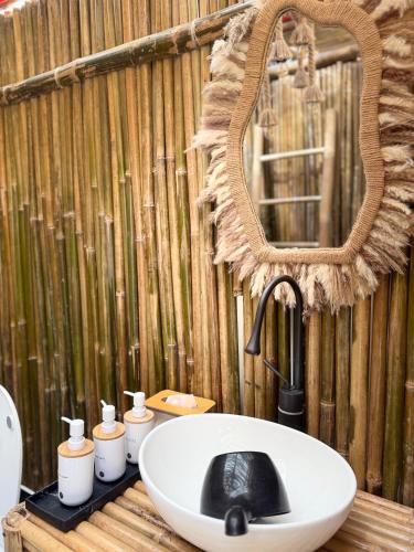 a bathroom with a white sink and a mirror at Cocoon De Coron in Coron