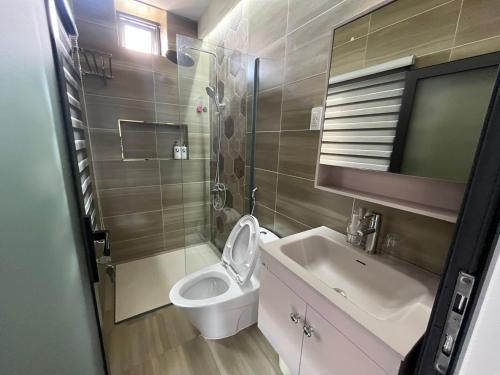 a bathroom with a toilet and a sink at Roooftop villa can ho penhouse Tay ninh in Tây Ninh