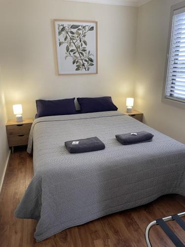 a bedroom with a large bed with two pillows on it at Tumby Bay Caravan Park in Tumby Bay