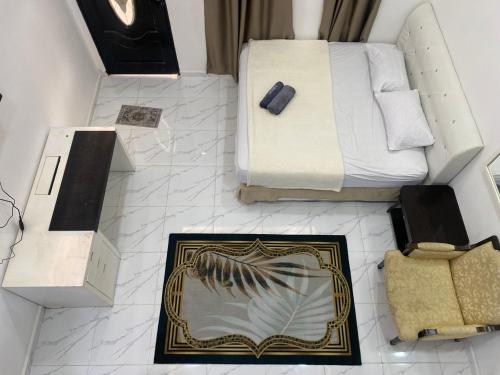 a bedroom with a bed and a picture on the floor at D'Alor Homestay in Pasir Mas
