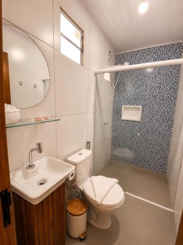 a bathroom with a toilet and a sink and a shower at Shalon Adonai by Martinelli Lodge in Fernando de Noronha