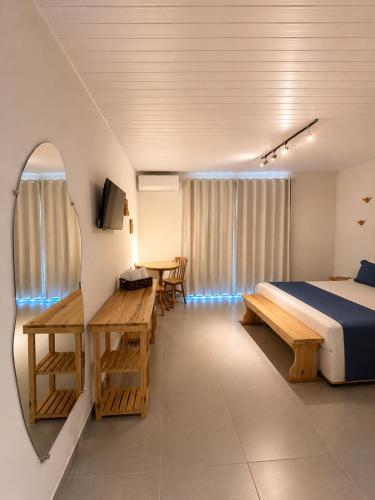 a bedroom with a bed and a table and chairs at Shalon Adonai by Martinelli Lodge in Fernando de Noronha