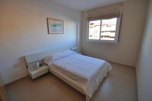 a small bedroom with a bed and a window at Apartments-Lloretholiday-Marfull in Lloret de Mar