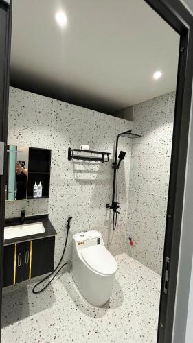 a bathroom with a toilet and a sink at Minimalhaven Stay in Vung Tau