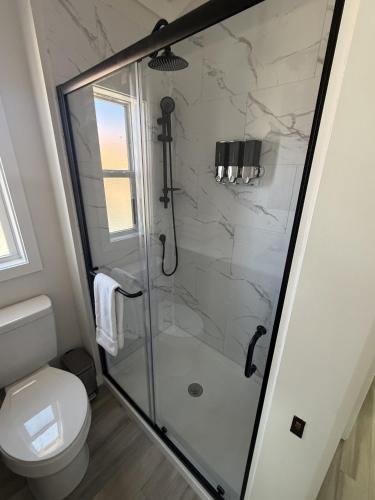 a bathroom with a glass shower with a toilet at Roam America Horseshoe Bend in Page