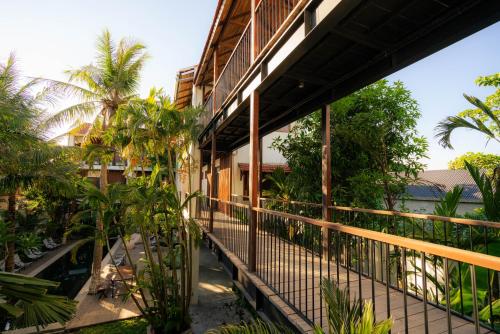 a balcony of a building with trees and plants at The Laneway Hostel in Xuân Sơn