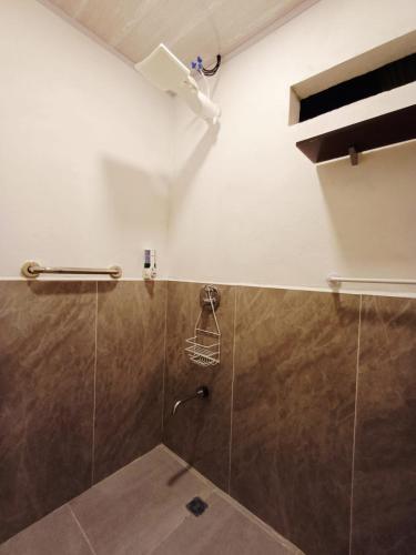 a bathroom with a shower with a glass door at Camping Green house in Palma