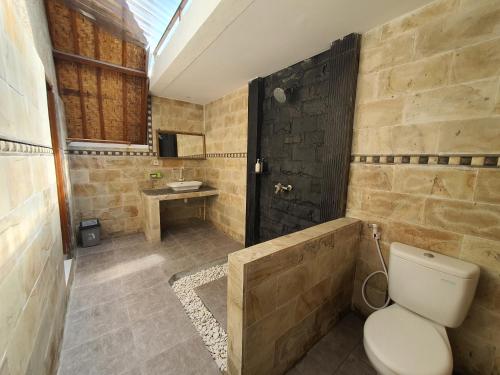 a bathroom with a toilet and a sink at G Two Cottages in Gili Islands