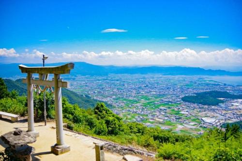 a cross on top of a hill with a city at 縁-en- in Zentsuji