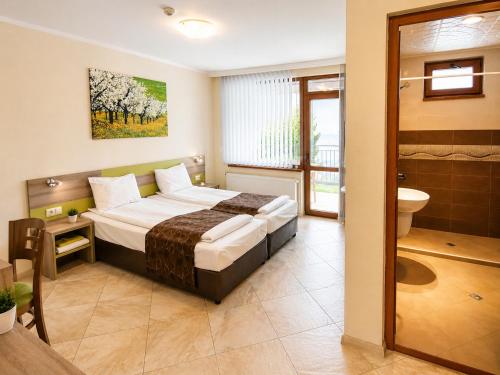 a hotel room with a bed and a bathroom at Къща за гости Пролет in Valevtsi