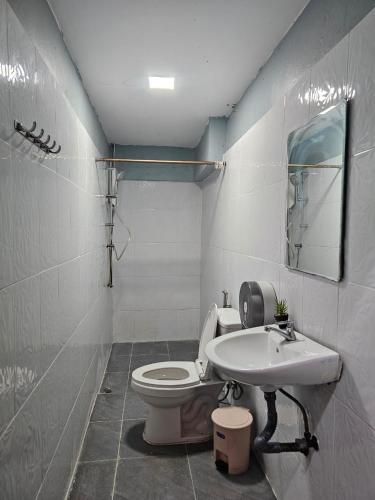 a bathroom with a toilet and a sink at Pakse Green Adventure Hostel Two in Pakse