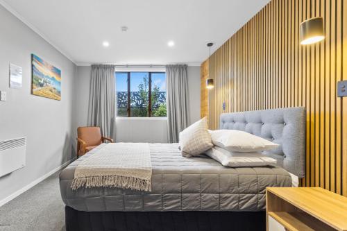 a bedroom with a king sized bed and a window at Manowhenua Lodge Hostel in National Park