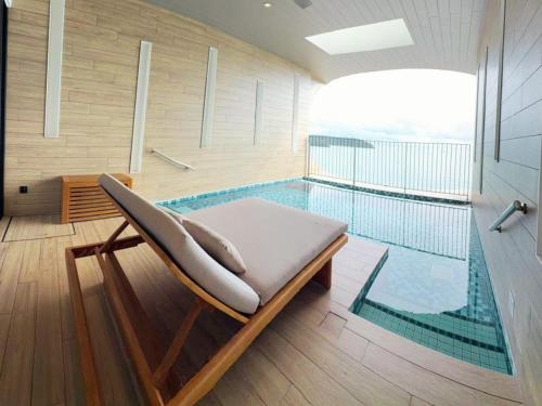 a swimming pool with a chaise lounge next to a swimming poolasteryasteryastery at PARKROYAL Langkawi Resort in Pantai Cenang