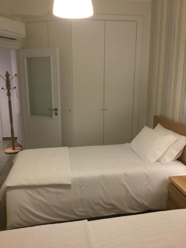a bedroom with a white bed with a cross on it at Central & Charming Clérigos Appartments in Porto