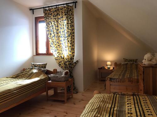 two twin beds in a room with a window at Villa Tourmaline in Kremnica