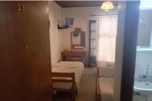 a bathroom with a bed and a sink and a mirror at samos town hostel in Samos