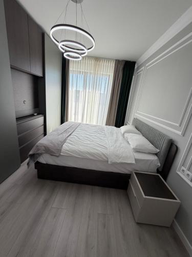 a bedroom with a bed and a large window at Best Luxury Residence in Bistriţa