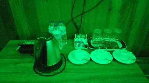 a table with a blender and glasses and water bottles at Diamond Hotel in Kagha