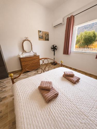 a bedroom with a bed with two pillows on it at Mani Spot Manani in Pyrgos Dirou