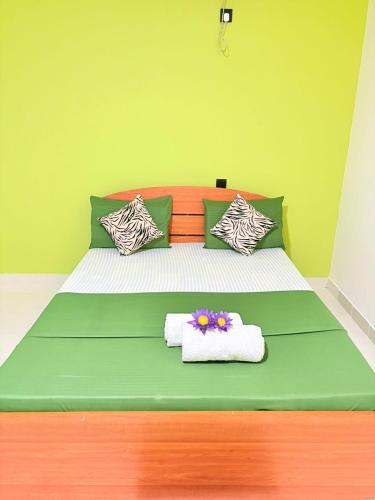 a bedroom with a bed with towels and flowers on it at The Wild Lotus YALA in Tissamaharama