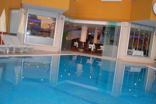 a large swimming pool in a hotel room at Atak Apart Hotel in Alanya