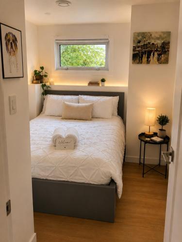 a bedroom with a bed with a heart pillow on it at Okanagan Valley Beautiful 2 beds 2 bath in Vernon