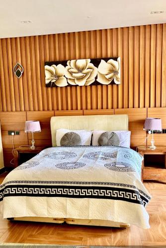 a bedroom with a bed with flowers on the wall at Deluxe unique homes kampala in Kampala