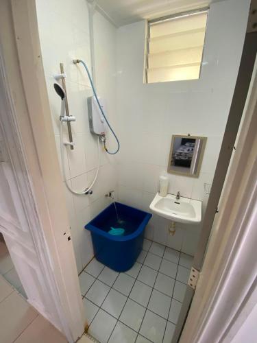 a bathroom with a blue toilet and a sink at DRIFF Homestay 3bedroom with aircond 50m to Night Market Wakaf Che Yeh in Kota Bharu