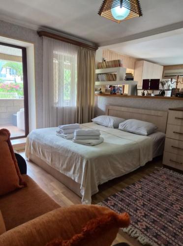 a bedroom with a large bed with towels on it at Buknari in Buknari