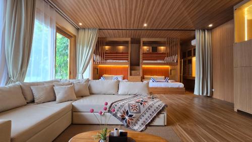 a living room with a white couch and a table at Palmelía Beach Resort in Buruanga