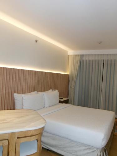 a hotel room with a large bed and a table at Alasra Suites in Ulot