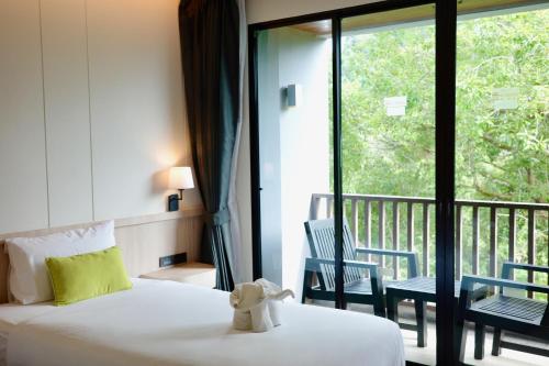a hotel room with a bed and a balcony at Aree Tara Ao Nang Krabi in Ao Nang Beach