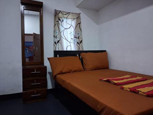 a bedroom with a bed with a dresser and a mirror at New Guest in Nilaveli