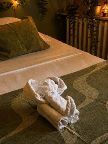 a towel is sitting on a bed at Hotel Cayrons Vence & St Paul de Vence in Vence