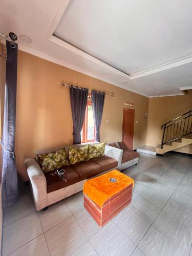 a living room with a couch and a coffee table at Villa Pondok Aurora in Campaka