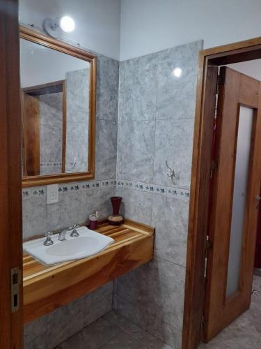 a bathroom with a sink and a mirror at Departamentos Malargue in Malargüe