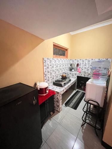 a kitchen with a stove and a counter top at Villa Pondok Aurora in Campaka