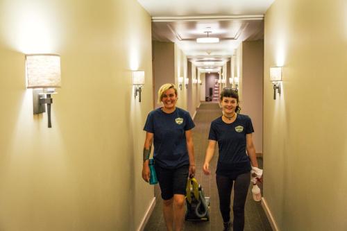 two women walking down a hallway in a hotel room at Rush Creek Lodge at Yosemite in Groveland