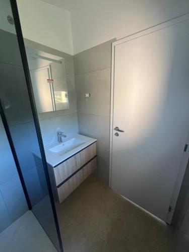 a bathroom with a sink and a mirror at Olive Garden Studio in Izola