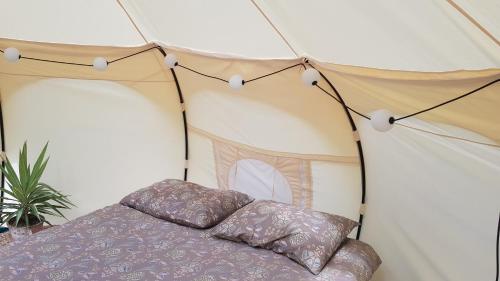 a bedroom with a bed in a tent at Old Mill Glamp in Kozov