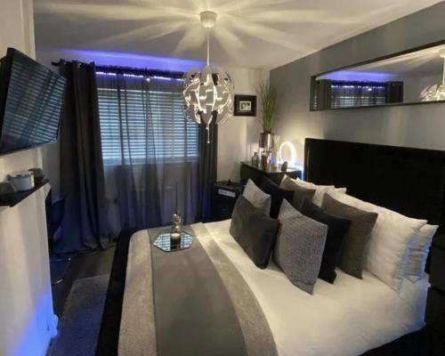 a living room with a large white couch with pillows at The Grand Avora Apartment With 3 Ac And Free Parking in Lahore