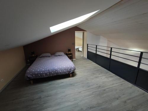a bedroom with a bed and a balcony at Augustobona in Lévigny