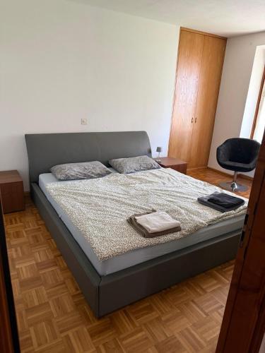 a bedroom with a bed with a gray bed frame at Executive Lake View with Private Garden in Lugano