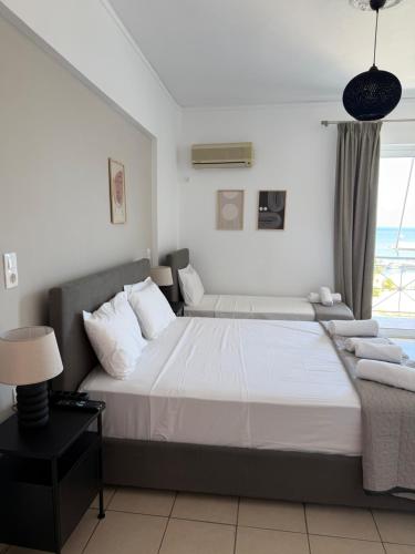 a bedroom with a large bed and a window at Angelika Rooms in Longá