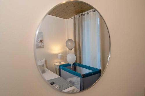 a mirror on a wall with a blue table in a room at Alivio Country House in Nafplio