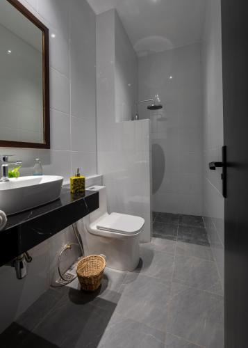 a bathroom with a toilet and a sink and a mirror at Inpeng View Hotel in Vientiane