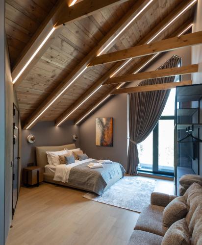 a bedroom with a bed and a large window at Monte SPA Villas in Banya