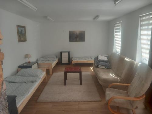 a living room with a couch and a table at Noclegi Puńsk w centrum 50 m in Puńsk