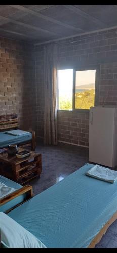 a room with two beds and a window at Caslune in El Bidha