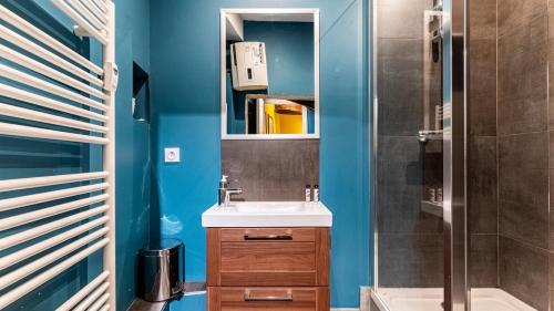 a bathroom with a sink and a mirror at Maison Wilson - Dijon centre - very quiet in Dijon